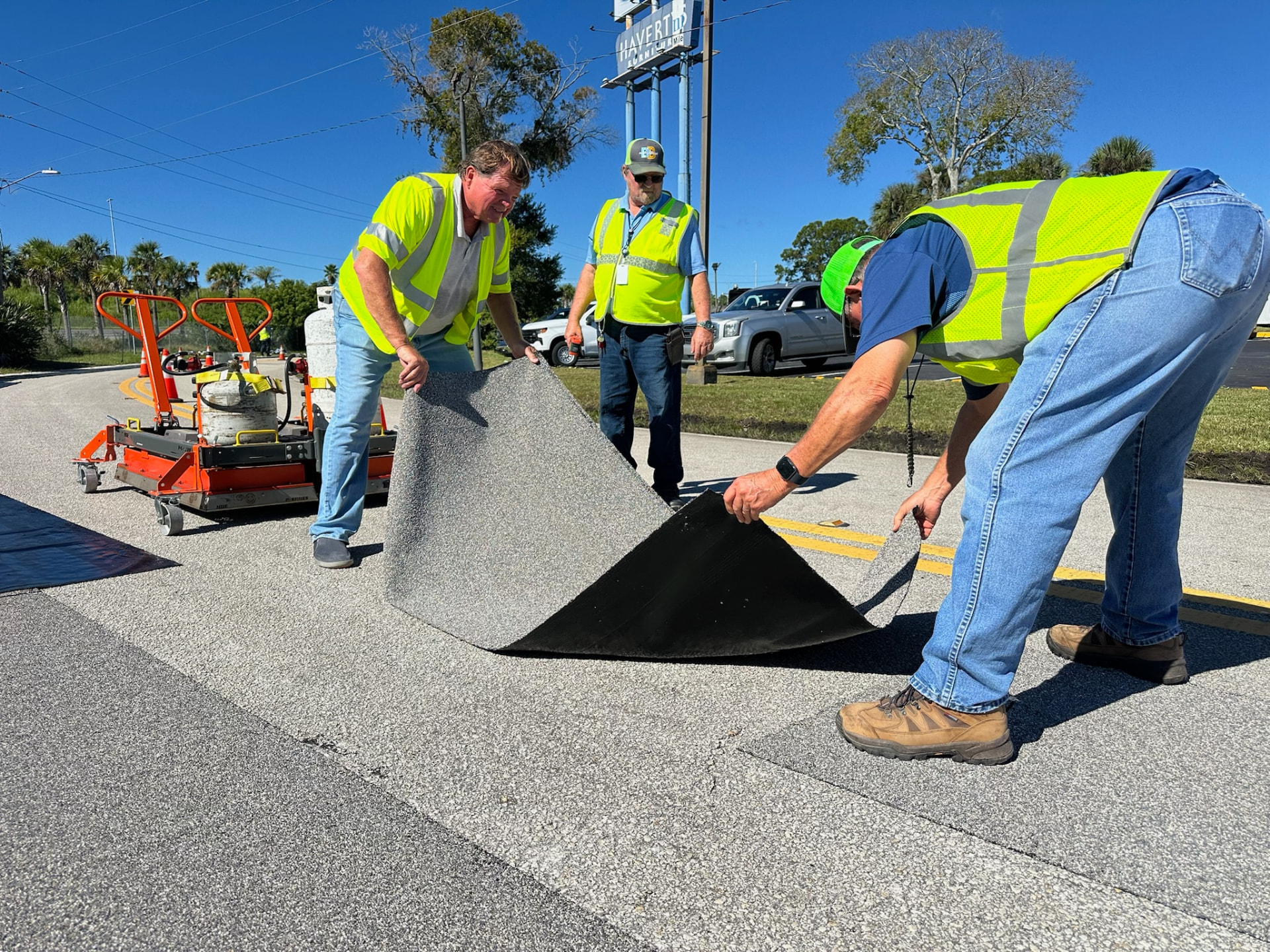Crew installing Roadway Safety Strip high-friction surface material on a Florida roadway